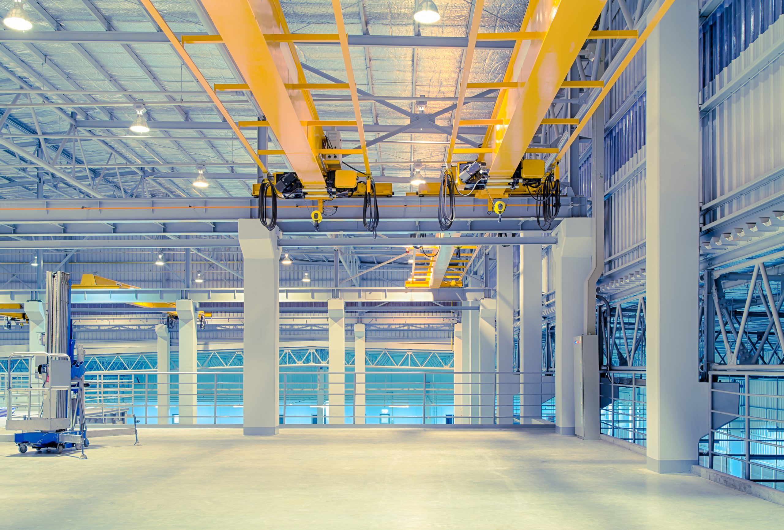 Inside an industrial warehouse for rent, with overhead gantry.